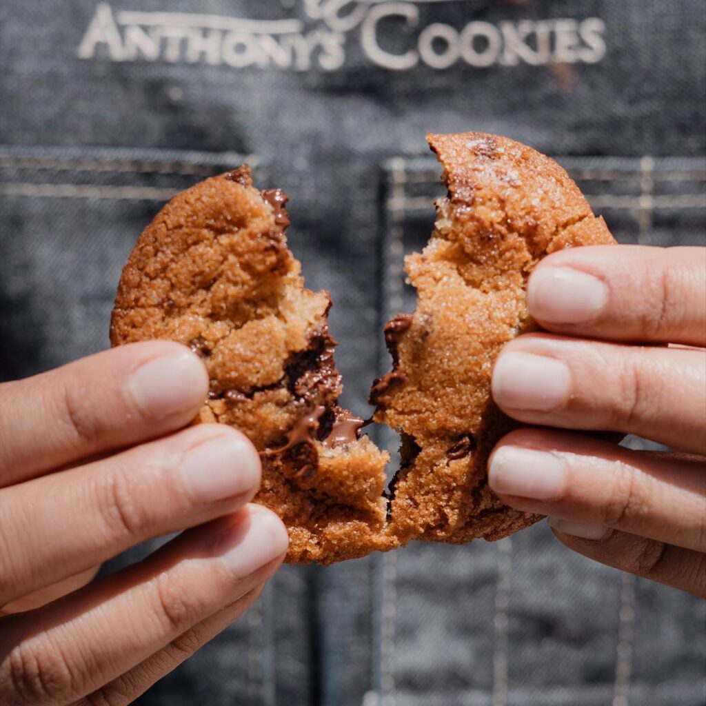Anothony's cookies being held and opened by the baker