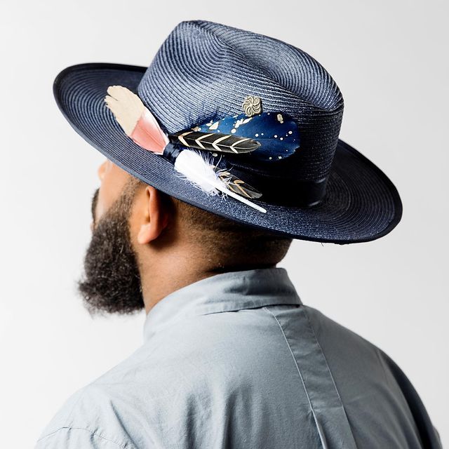 A Blue fedora with feathers from Black Owned Hat Company, Fruition Hat Company