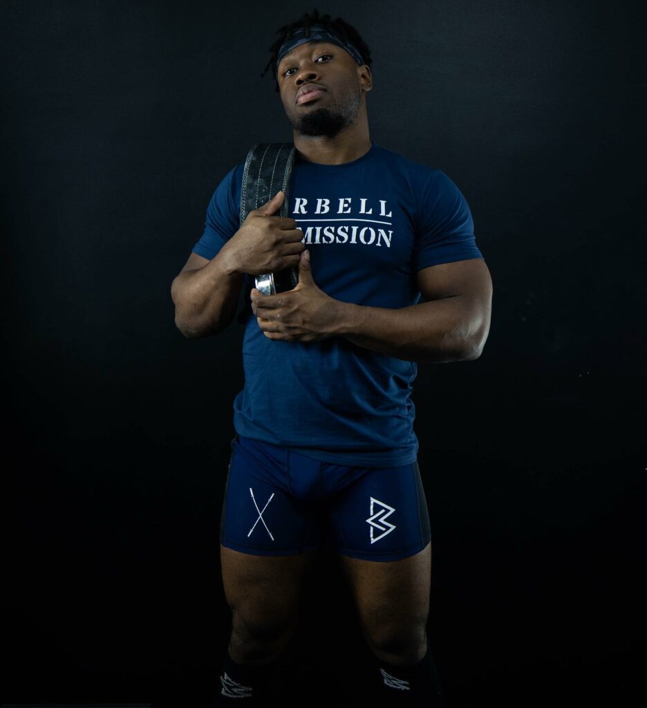 Weightlifter wearing a barbell commission t-shirt and shorts set in blue