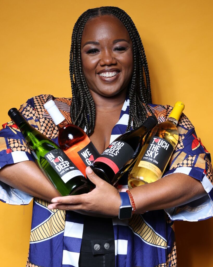 Love, Corkscrew Wine founder Chrishon Lampley holding her four wine varieties