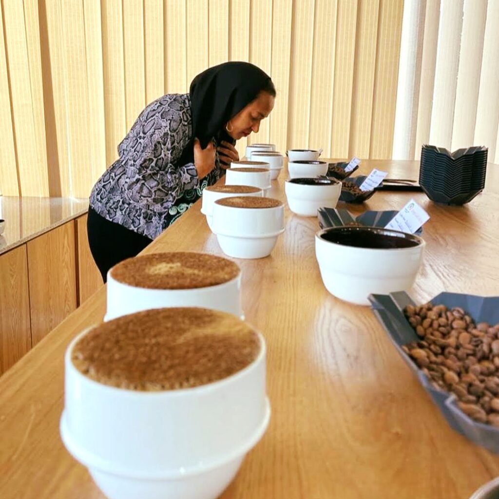 AT Oasis owner Aisha inspects different coffee beans