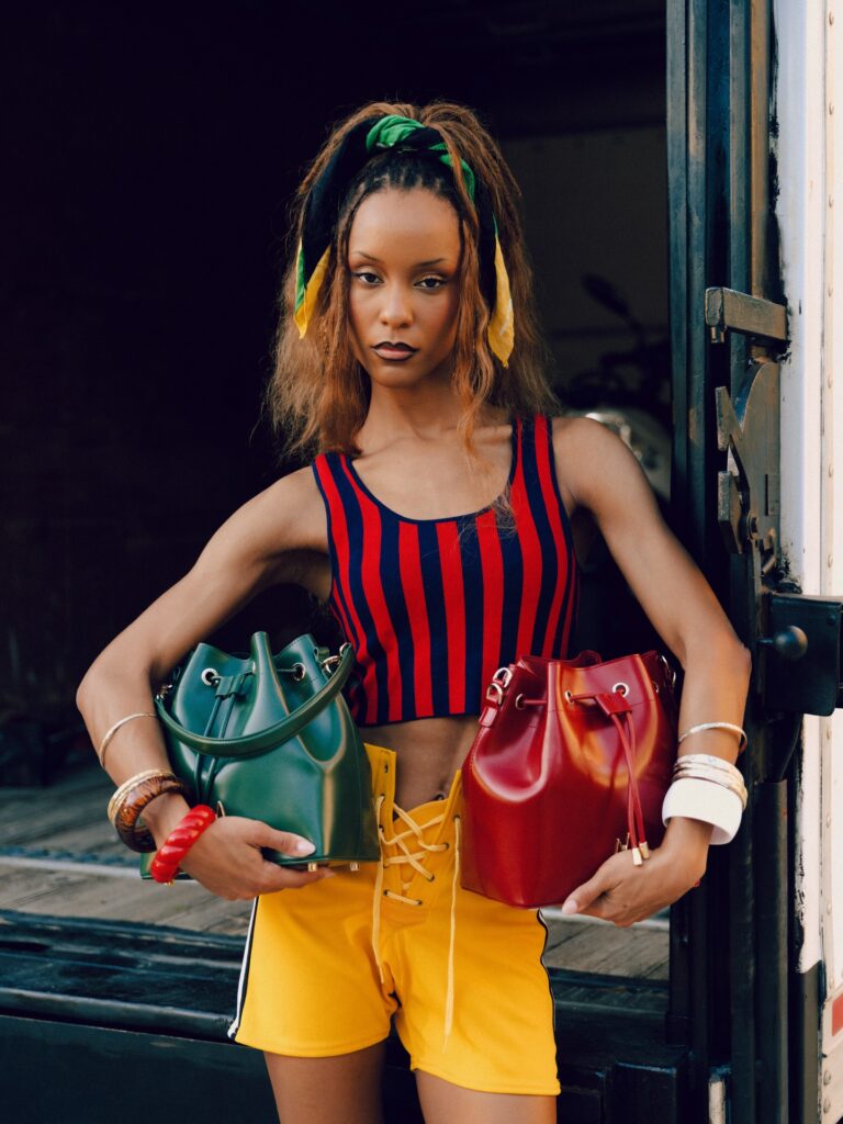 Model holding two maya winston bucket bags